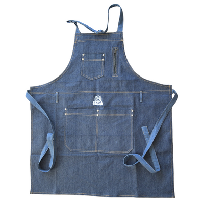 A heavy-duty blue denim bib apron with multiple utility pockets, gold-tone rivets, and adjustable ties, featuring a centered white logo.
