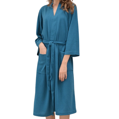 Teal robe worn by a person on a white background