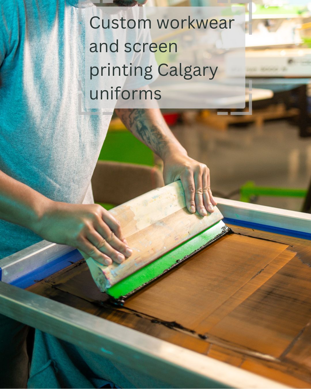 Worker performs screen printing for custom Calgary uniforms and workwear at Beaver Dam Attire.